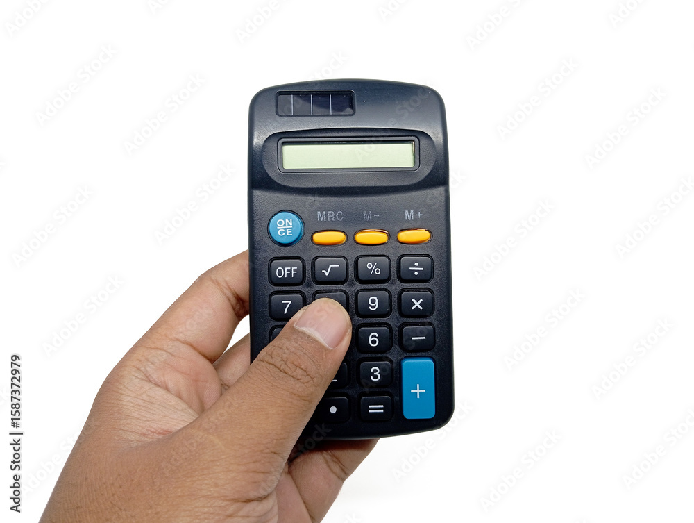 A hand is holding and pressing buttons on a dark-colored calculator with yellow and blue accents, isolated against a bright white background, conveying action in calculation or accounting. A hand is holding and pressing buttons on a dark-colored calculator with yellow and blue accents, isolated against a bright white background, conveying action in calculation or accounting.