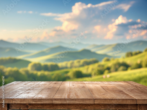 Empty rustic wooden table with a blurred background of rolling green hills under a bright, sunny sky with clouds.