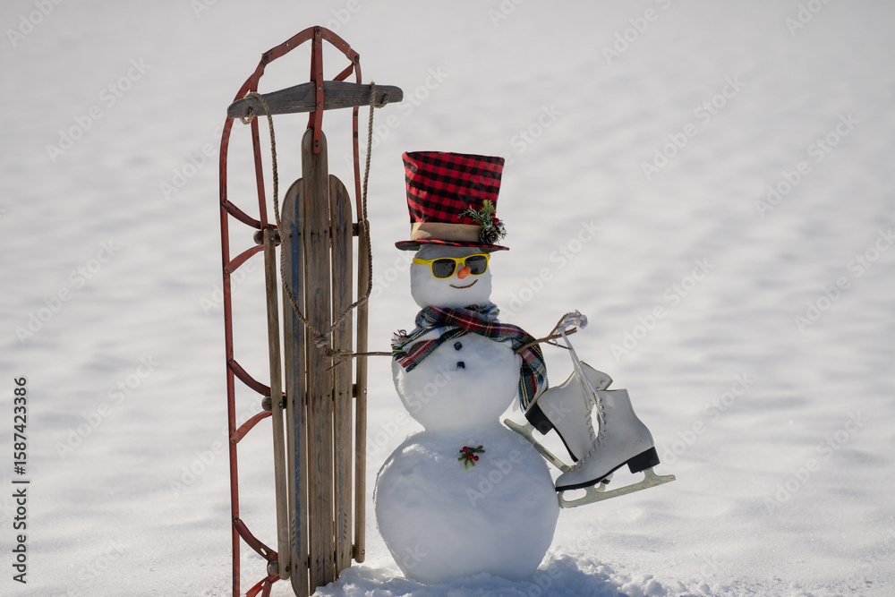 Obraz premium Snowman on snow background. Winter holiday scene. Snowman with scarf and hat. Snow design. Happy snowman outdoor. Snow banner. Frosty snowman. Winter greeting card. Cute snow man.