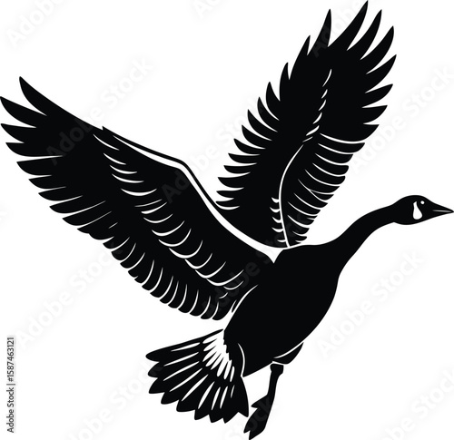 Black silhouette of a goose in flight with wings spread wide bird flying