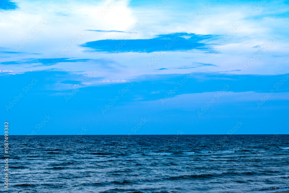 Fototapeta premium Nature of the ocean and blue sky Summer with sunshine, sandy beaches, clear blue waters sparkling against the blue sky. on an island with good ecology and environment Background for summer vacation