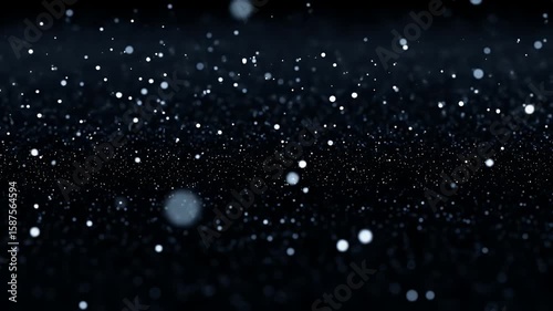 Glittering white particles against a dark blurred background