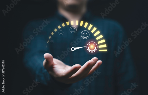 Фотография Customer evaluation indicator rating on businessman hand since low to high with smiley face for client customer satisfaction after use product and service  concept