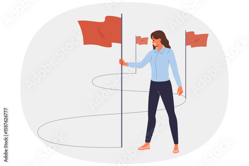 Business woman walks path to success and inserts winner flags on way to achieving professional goals. Lady manager implements tasks and consolidates success thanks to motivation and personal ambitions