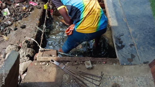 Murky Pit Surrounded by Garbage and Waste