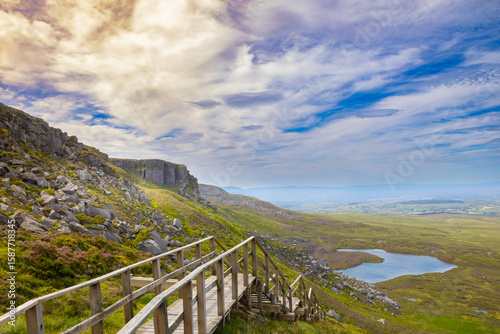 Stairway to Heaven boardwalk on Cuilcagh Mountain with scenic hills, rocks, and lake view