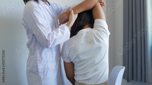 Asian female patient undergoing physical therapy with a physical therapist after suffering from prolonged and intolerable pain. She underwent pain management in a hospital.