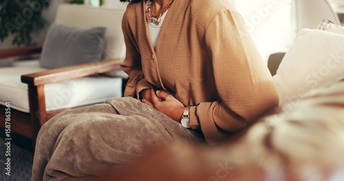 Papier peint Woman, hands and cramps or pain on sofa for menstruation, ovarian cysts and discomfort in lounge