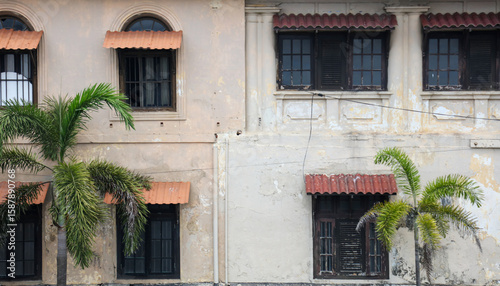 A building with a red roof and brown shutters