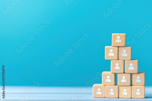 Building a strong team  wooden blocks with people icons on blue background for hr management concept