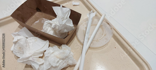Photos Used paper napkins disposable tableware cardboard box plastic straws dirty food