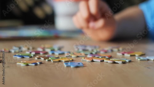 Child's Hand Picking Puzzle Piece