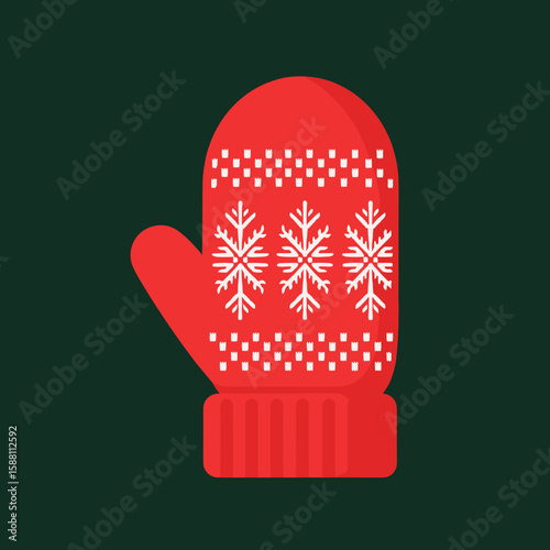 Red knitted mitten with snowflake design on dark green background  