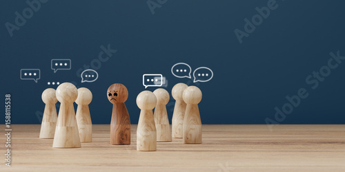 Sad wooden figure excluded from group. Concept of bullying, discrimination, isolation, loneliness, and mental health in society, workplace or school.