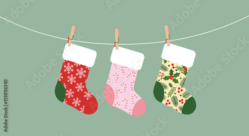 Colorful Christmas stockings hanging on a line against green background  