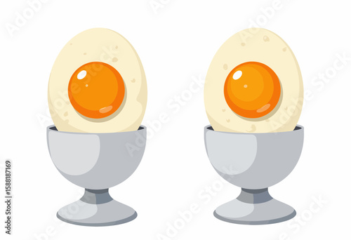Two boiled eggs in silver egg cups with orange yolks  
