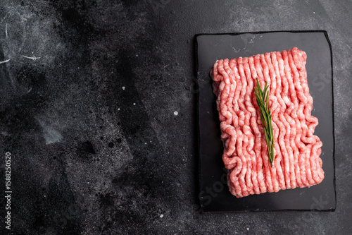 Raw ground pork meat, mincemeat. black background. top view