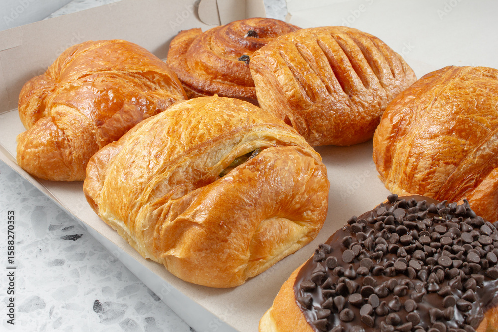 Fototapeta premium A view of a box of assorted breakfast pastries.