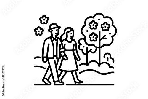 Couple walks in a park surrounded by blooming flowers during a sunny day in spring