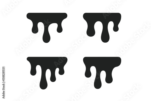 Dripping black liquid shapes create a striking visual texture on a white background at a modern art installation