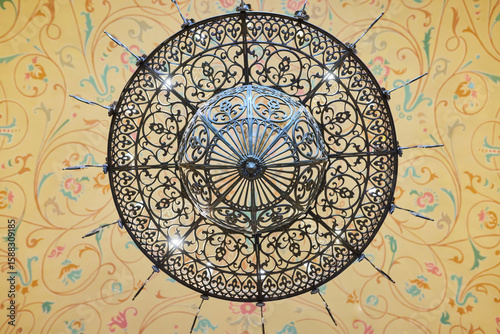 Antique chandelier on the ceiling with painting