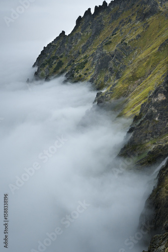 Mountain peaks above the clouds. Landscape of the High Tatras.

