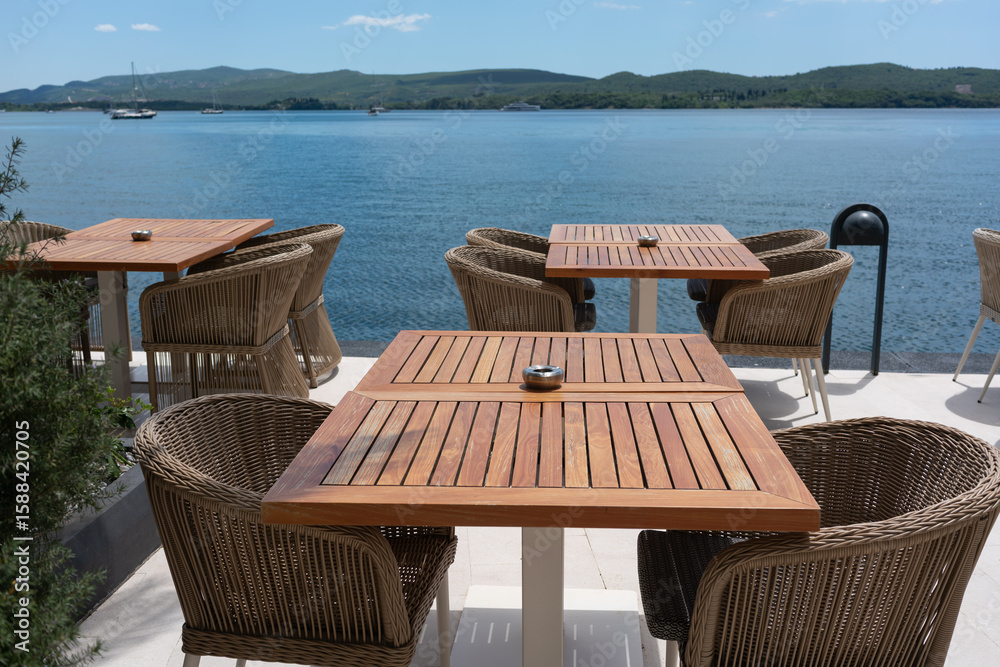 Fototapeta premium Wooden cafe tables with sea view