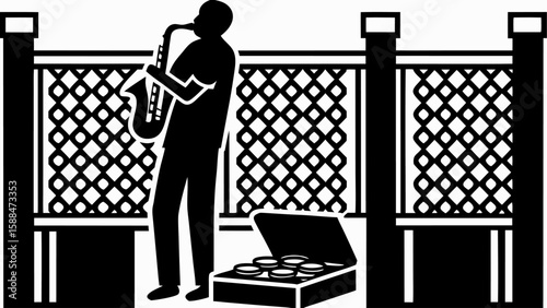 Silhouette of a saxophone player performing near a fence with a case of coins on the ground near him