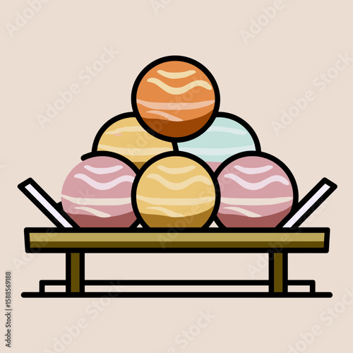 Colorful spherical objects arranged in a pyramid formation on a wooden tray, featuring orange, yellow, light blue, and pink spheres with wavy white lines