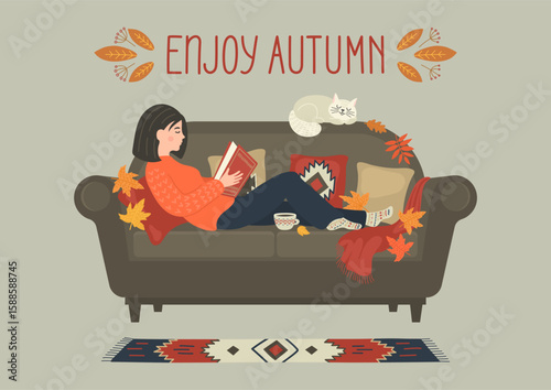 Enjoy autumn. Woman reading book on cozy sofa at home.