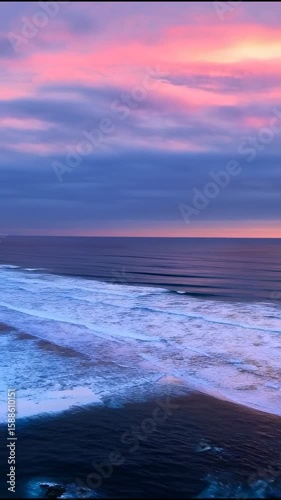 Stunning Sunset Over the Pacific: A Vibrant Coastal Panorama with Rolling Waves and Lush Greenery