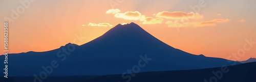 majestic mountain range emerges dark silhouette warm peach blue gradient sky set ablaze golden hues