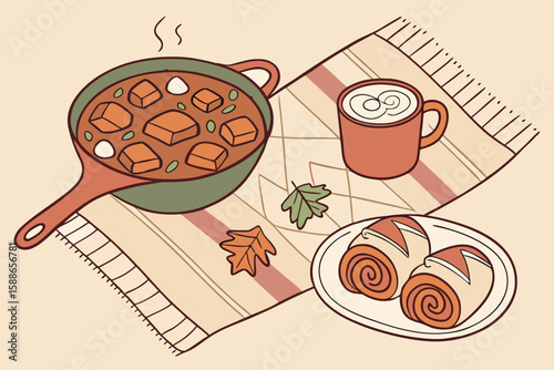 Still life of a pot of stew, mug of coffee, and cinnamon rolls on a striped blanket with leaves