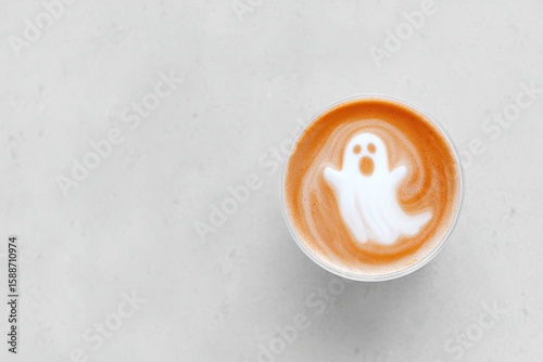 Ghostly Latte Art in Coffee Cup on Minimalist Background - Halloween Theme.