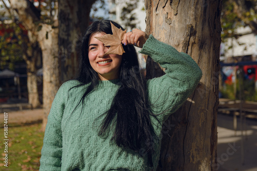 Young woman enjoying the change of season in her town square