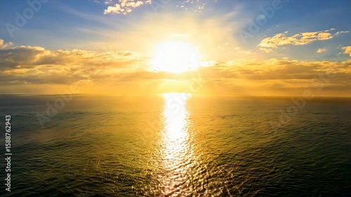 A timelapse of a massive sun rising over a calm ocean horizon