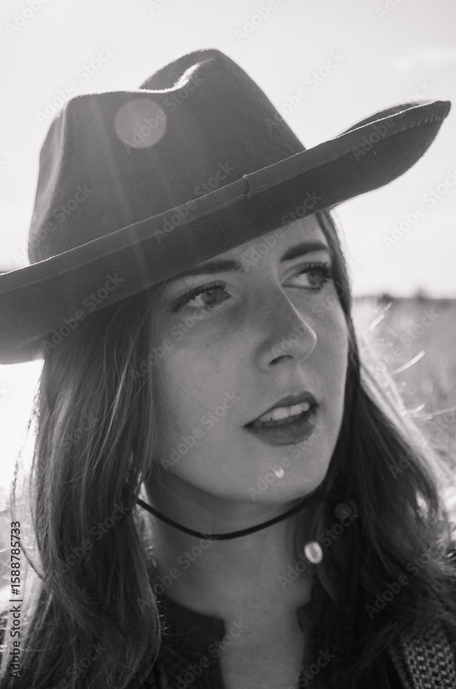 A girl with a guitar in cowboy style. Cowboy hat and boots. Sunny atmospheric photos. A girl with a guitar in cowboy style. Cowboy hat and boots. Sunny atmospheric photos.