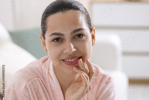 Young woman with lip balm at home Free Download Young woman with lip balm at home - GFXLoad