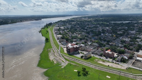 New Orleans, Louisiana urban neighborhood on the banks of the Mississippi River with Levees earthen embankments to control flooding from the river is also walking biking trail