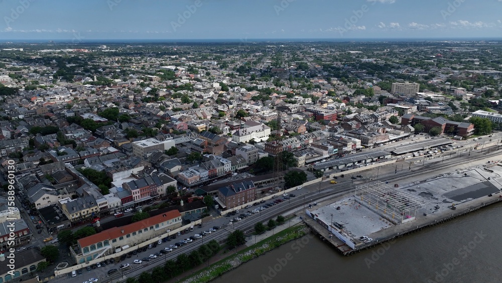 Obraz premium Aerial of residential urban neighborhood homes located in downtown New Orleans, Louisiana with streets and trees during summer heat wave