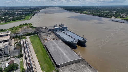 Shipping and transportation on the Mississippi River at New Orleans, Louisiana early morning sunshine on water during summer heat wave
