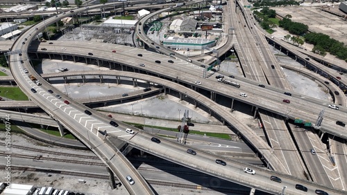 Aerial view of interstate highway exchanges with cars and trucks driving over industrial area of New Orleans, Louisana downtown traffic
