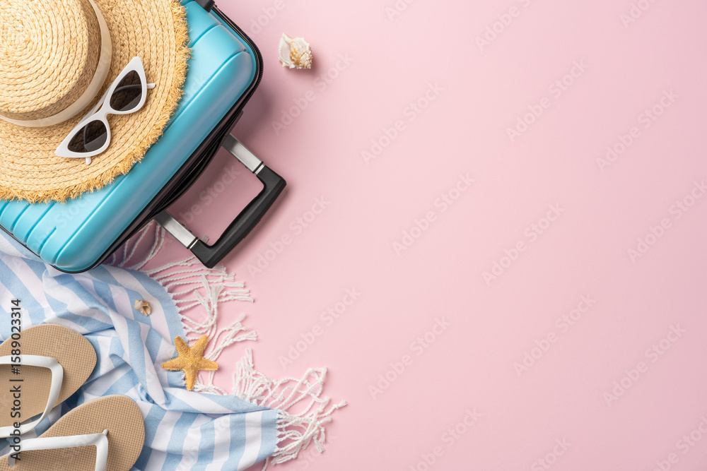 Fototapeta premium Flat lay of vacation items including blue suitcase, sunglasses, hat, and beach essentials