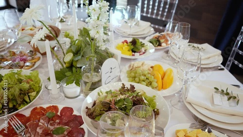 Catering service on banquet table with canape snacks in restaurant or hotel. Decorated food set on birthday, wedding celebration or business conference event venue