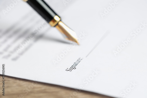 Photography Signing notary document with fountain pen at table, selective focus