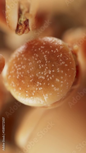 Animation of a group of burgers. Many burgers slowly rotate in the background in space. Vertical composition. Defocus. Close-up.
