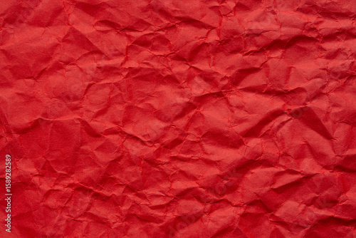 Macro red crumpled paper background,Red crumpled paper background, close up. Red sandy paper texture. Red wrapping paper as Christmas background.