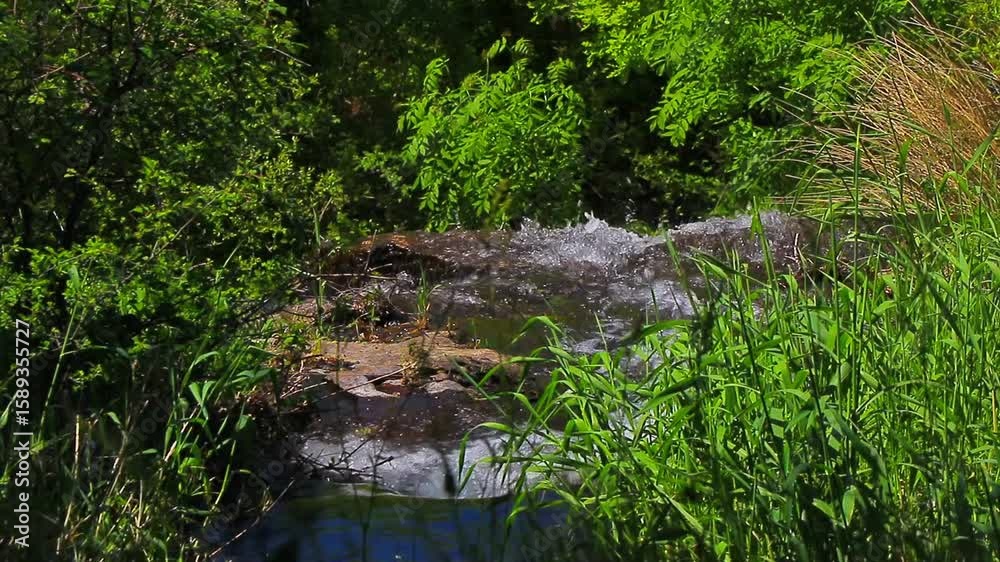 A 20-second still video of the Alzeau River waterfall in Saint Denis, Aude. A waterfall set amidst rocks in the south of France.

