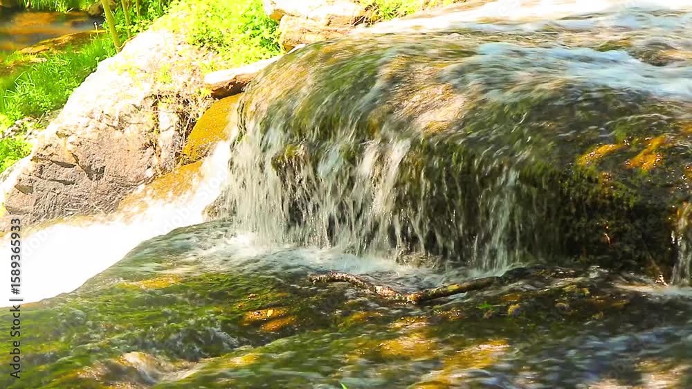 A 20-second still video of the Alzeau River waterfall in Saint Denis, Aude. A waterfall set amidst rocks in the south of France.

