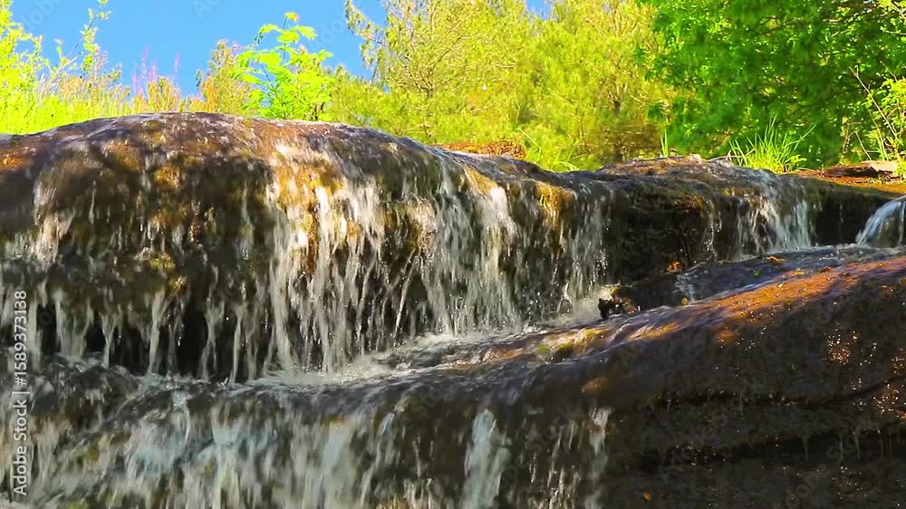 A 20-second still video of the Alzeau River waterfall in Saint Denis, Aude. A waterfall set amidst rocks in the south of France.
